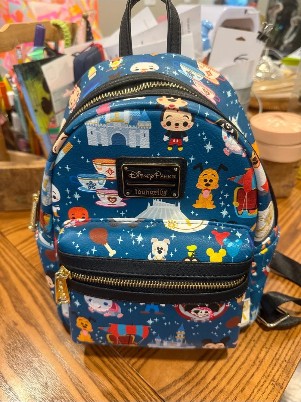 Loungefly Blue Mini Backpack with Colorful Theme Park Character Print